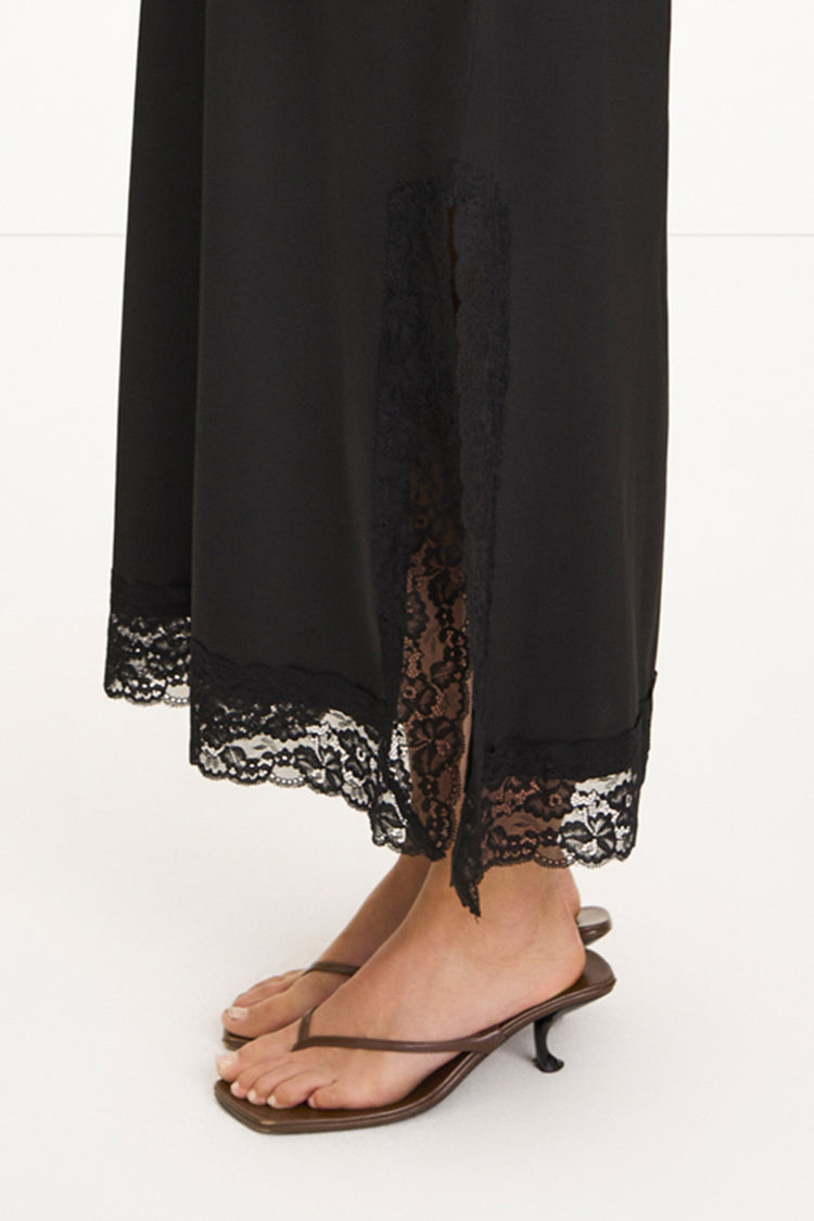 Malea black v-neck lace trim dress model image side close