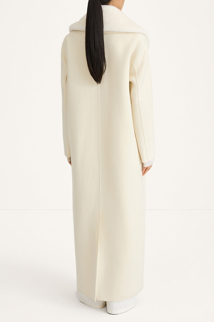 white maxi wool coat with a faux fur collar stylein tera thivona back