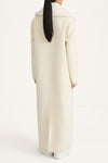 white maxi wool coat with a faux fur collar stylein tera thivona back