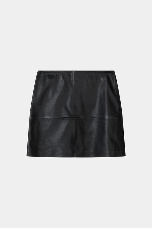 A black leather mini skirt with a structured, slightly cropped silhouette and a front seam detail, shown flat on a light gray background.