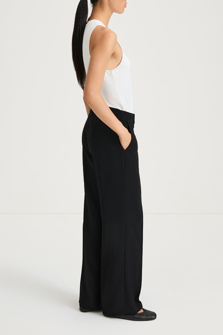Boris is a pair of loose fitted trousers with sewn creases, pockets on the sides and loops for a belt in the waist model image