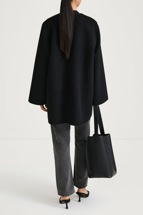 Black wool coat stylein tara back model image