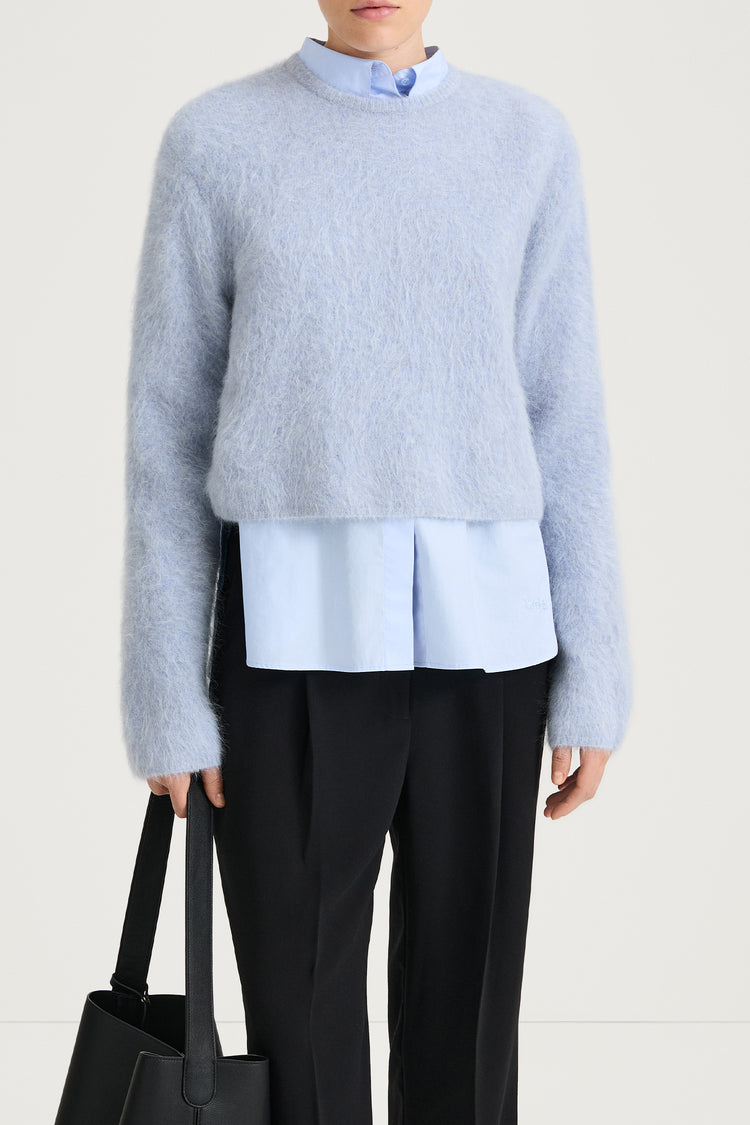 short cropped blue knitted sweater stylein close up