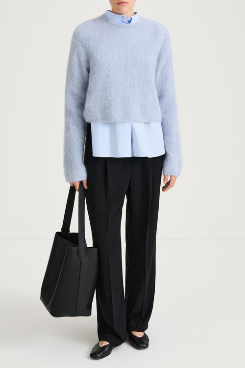 short cropped blue knitted sweater stylein front