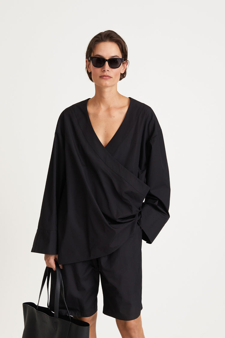 Johnny shirt voluminous v neckline overlapping front panels plates wide cuffs long sleeves black stylein front image