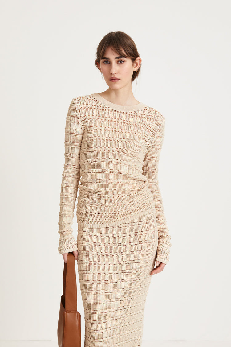 Peach top delicate knitted see-through top fitting silhouette full length sleeves cream stylein front image