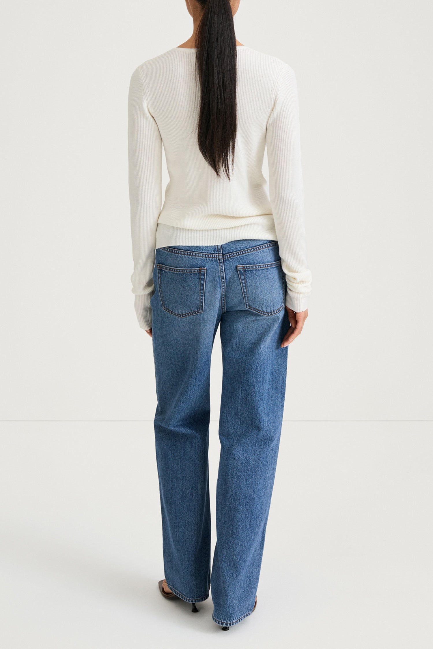 White buttoned cardigan stylein hamani back model image