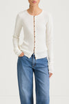 White buttoned cardigan stylein hamani front close up model image