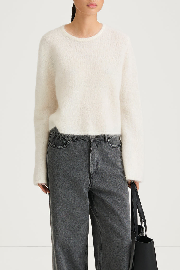 white knitted sweater stylein nima close-up